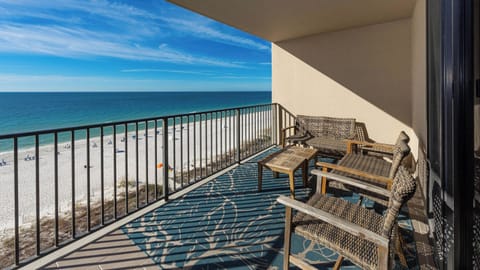 Relax on the balcony with comfortable seating and enjoy the expansive views of the tranquil waters and beach below