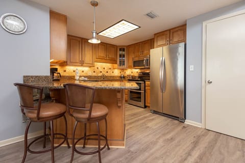 Enjoy cooking in this inviting kitchen featuring granite countertops, stainless appliances, and cozy seating for two