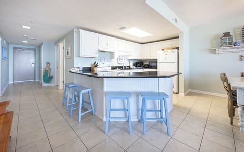 Gather around the spacious breakfast bar with seating, perfect for coffee and conversations during your stay