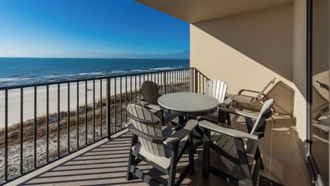 Relax at the outdoor balcony table, enjoying the refreshing breeze and expansive views of the tranquil water
