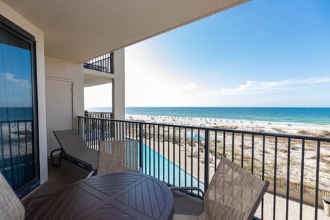 Relax on the balcony with comfortable seating and enjoy the expansive view of the water and the pool area