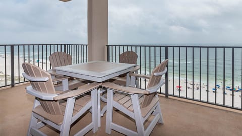 Dine al fresco at the outdoor table, enjoying refreshing breezes and views of the beach and waves below