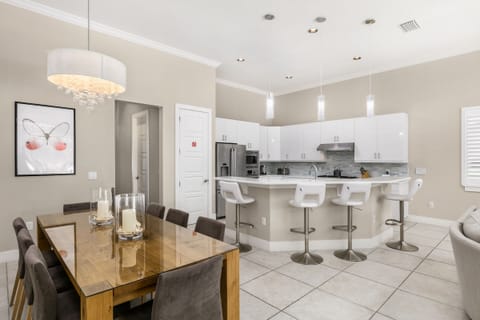 There is seating for 8 around the table and breakfast bar seating for 4