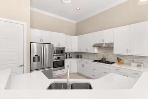 The kitchen has granite counters and stainless steel appliances