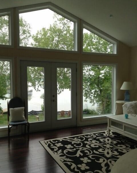 Great room with soaring vaulted ceilings and a spectacular view of the lake