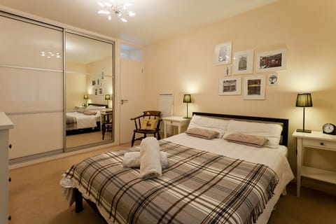 Bedroom: cupboards, door to bathroom, double bed