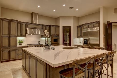 Chef's kitchen with stainless steel appliances, custom center island and bar seating for 6.