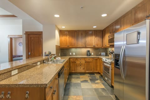 Kitchen open to living area. Granite counter, stainless steel appliances. Clean!