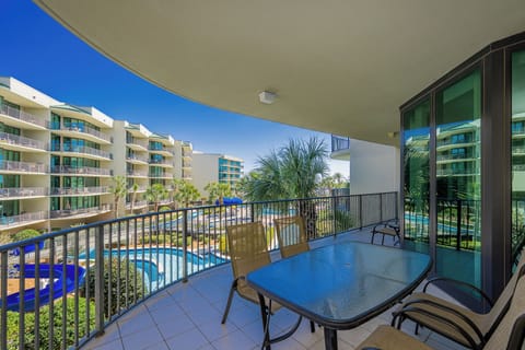 Savor the warm breeze while lounging on the balcony, soaking in views of the lush grounds and inviting pool