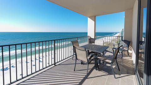 Enjoy meals or drinks at the outdoor table while taking in the expansive beach views from your balcony