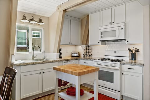 Kitchen equipped with cook ware, dining ware, small appliances and sanitation.