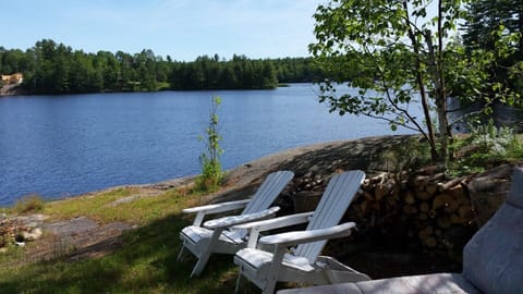 View of the lake including muskoka chairs