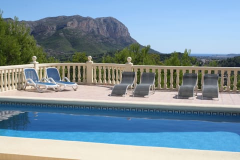 Pool surrounded by terracing with great views.