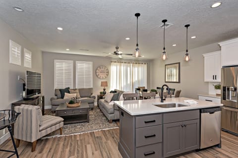 Kitchen Island & Living Room - The living room is designed as an open floor plan and is a great gathering place for meals, games, or watching TV during your stay.