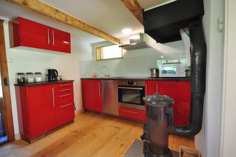 Modern fully equipped kitchen with traditional wood burner.