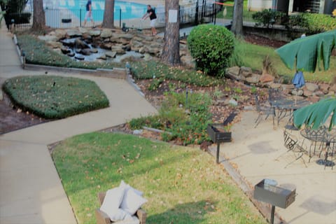 View of pool and grilling area from balcony