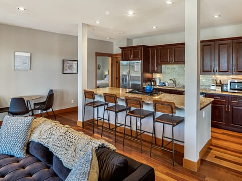 Fully stocked kitchen with bar seating for 4 and open concept to the living space