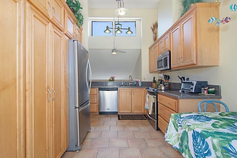 Kitchen looks over dining area and living room