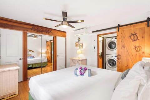 Enjoy ultimate convenience with an in-unit, stacked washer and dryer hidden behind a charming sliding barn door in this cozy bedroom suite
