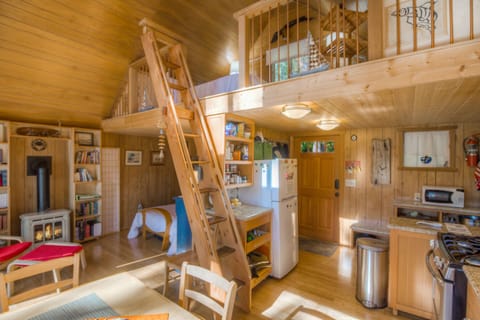 main cabin: upstairs loft for relaxation and reading with main floor queen bed alcove shown