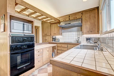 Kitchen- coffee maker, toaster, toaster oven and tea kettle.