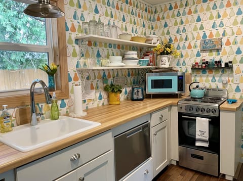 Microwave, apartment-sized electric oven/stove, and drawer dishwasher