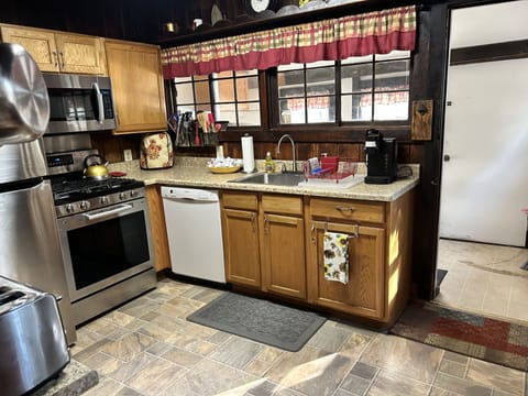 Our kitchen with a small storage area, back yard access and a view of the pond.