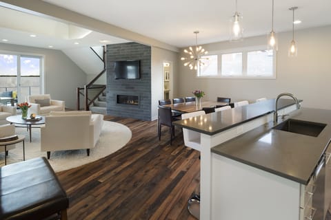 Relax in this stunning open-concept space where modern elegance meets comfort, featuring a cozy fireplace and chef's kitchen.
