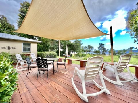 Large outdoor deck with landscape lights for nighttime enjoyment.
