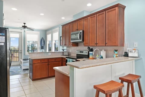 Fully equipped kitchen with additional bar seating on both sides of kitchen.