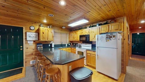 Fully equipped kitchen with appliances, pots and pans, dishes, utensils, and basic cooking essentials.