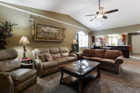Living area, sofa sleeper, recliner couch, recliner, and 55 inch TV.