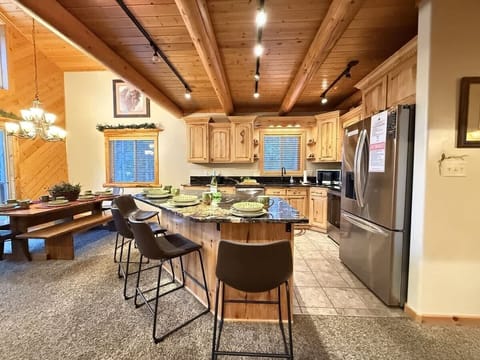 The open kitchen blends seamlessly into the cabin's cozy living area, creating a welcoming space perfect for gathering and unwinding.