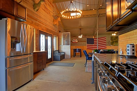 Kitchen has all the pots and pans, silverware, plates, bowls, sm. appliances