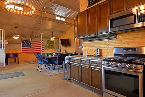 Fully stocked kitchen with microwave, stove, fridge, dishwasher, coffee maker