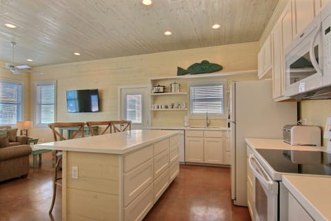 Kitchen - Open kitchen layout with plenty of counter space and coastal charm