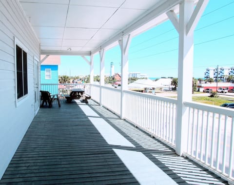 Deep wrap-around veranda with picnic table and sitting area to enjoy Gulf views.