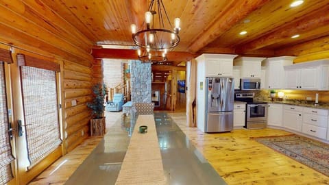 Overall, this dining room is a place where friends and family can gather, share meals, and enjoy the connection between nature and the comfort of a well-loved cabin home.