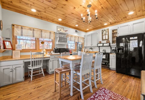 Full Kitchen and Dining Area with Bright Lighting