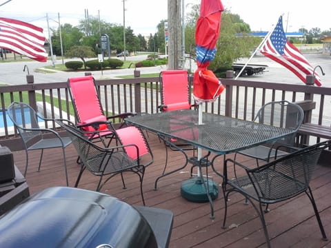 Deck Area with gas grill and patio seating with umbrella