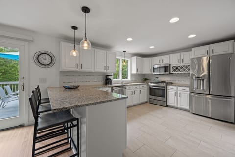 Large updated kitchen fully equipped, sliding glass door leading to deck