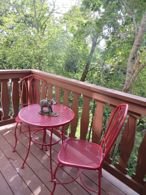 Master bedroom deck with sitting area surrounded by nature