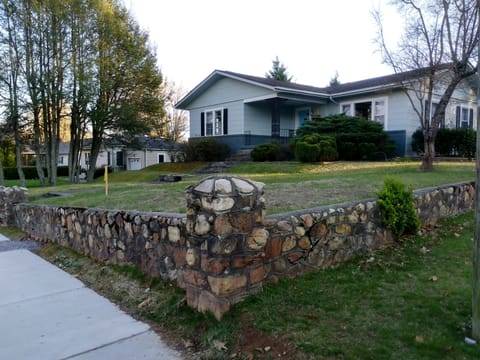 front. We're on the corner surrounded by a beautiful stone wall.