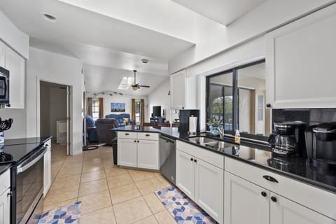 New well stocked kitchen with skylights and view to family room and laundry. 
