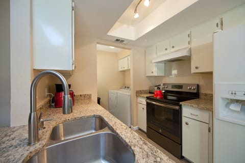 Kitchen area, microwave, toaster, washer and dryer.