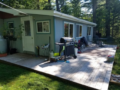 Lake side of house, grills, deck, table and chairs