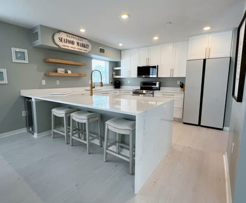 Completely updated kitchen, with all the necessities of home, in - Completely updated kitchen, with all the necessities of home, including bar stool seating, and a wine fridge.