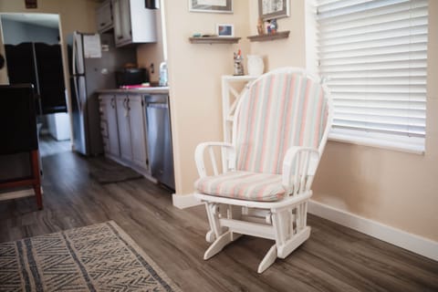 Rocking chair for nursing moms with inspiring books right next to you.