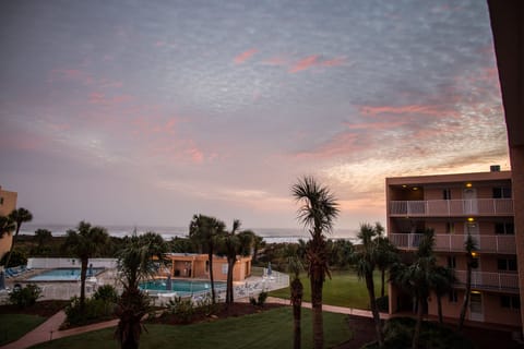 Beautiful sunset casts its rays on sky outside our window! Note view and pools!
