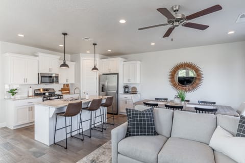 Living Room View - The Kitchen Island comfortably seats 3 adults and creates a great space for serving and preparing meals.